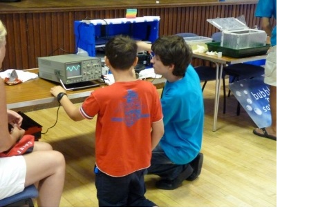 A male volunteer running an experiment at the Cambridge Hands-On Science Roadshow event.