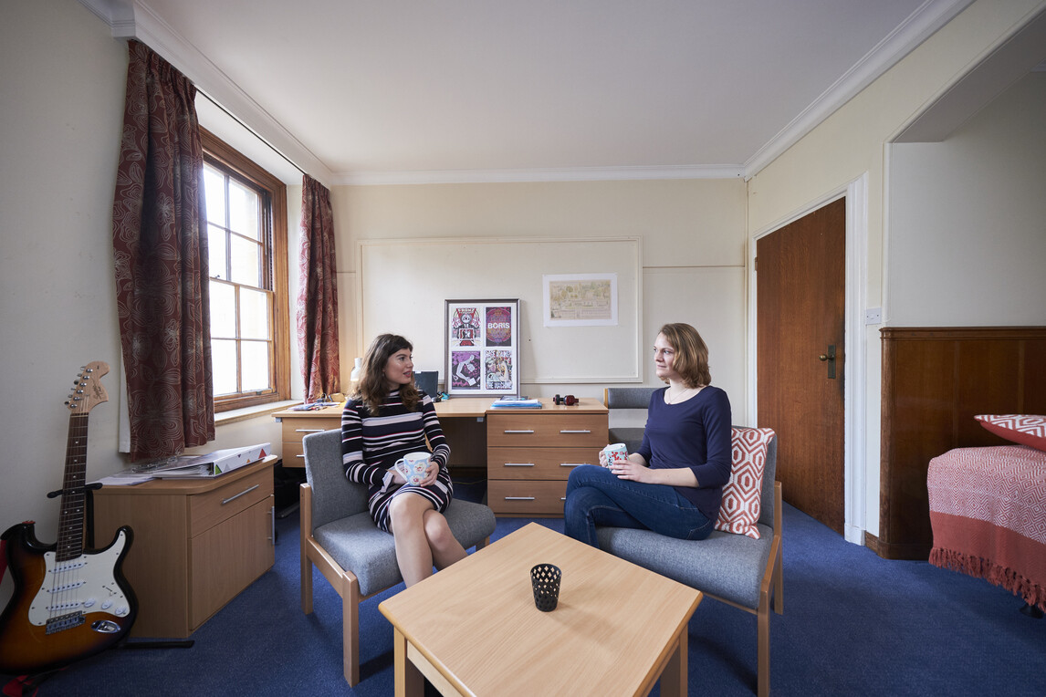 2 females sat at coffee table