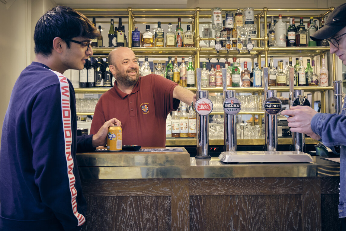 Student with fanta at bar