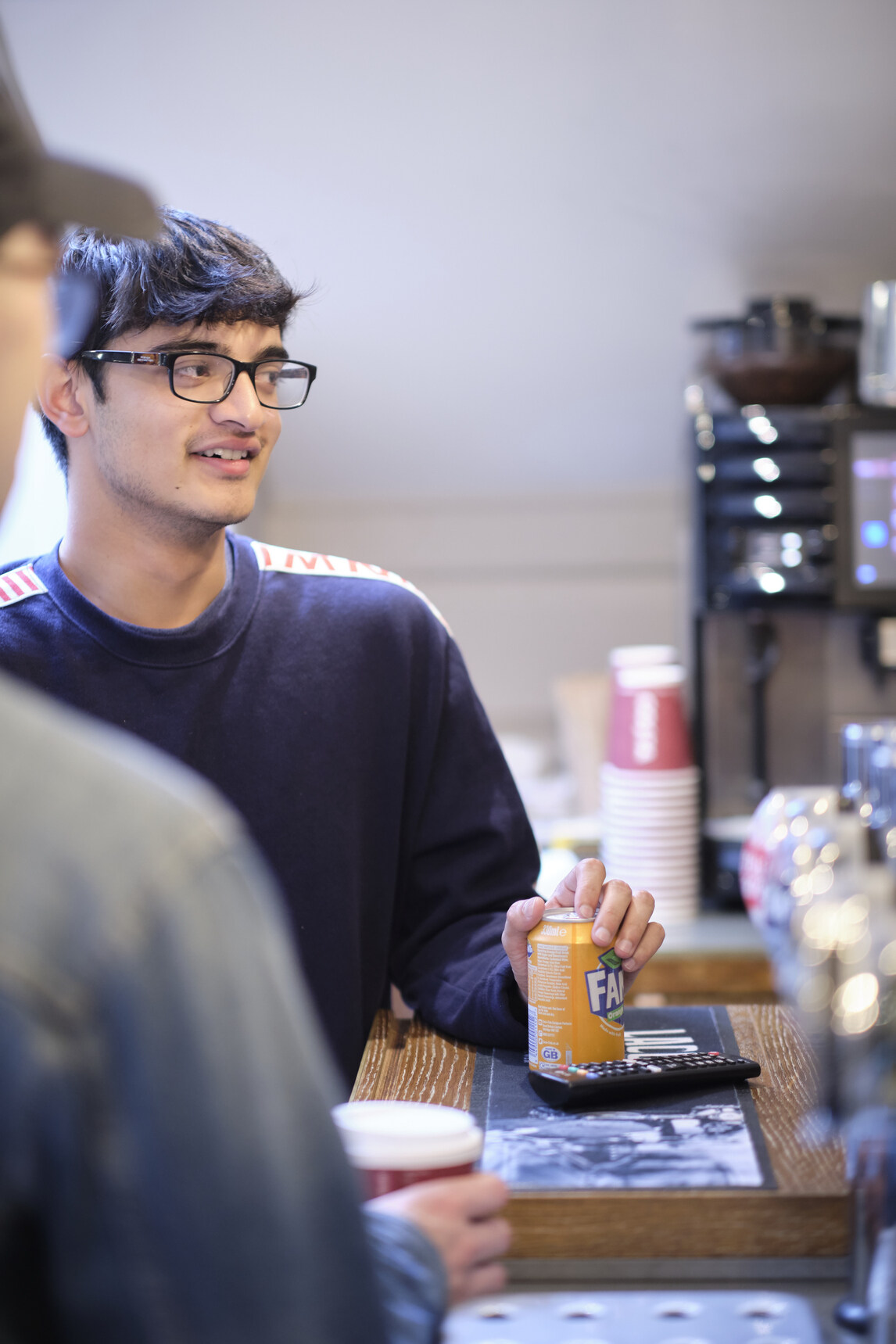 Male student at bar with Fanta