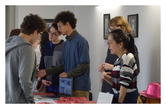 Students talking at stand.