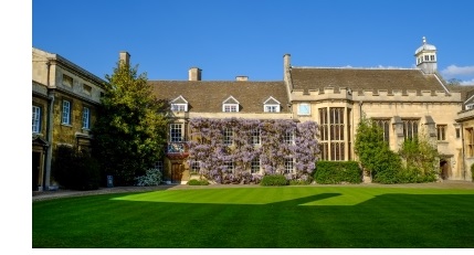 First Court in Christ's College Cambridge, showing the circular lawn and the front of the Master's Lodge, which is covered in purple wysteria.
