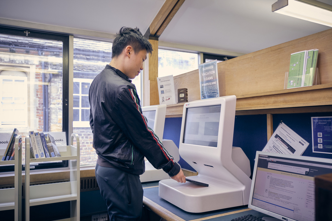 Student using self service checkout