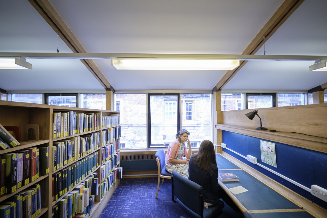 Two students at library desk