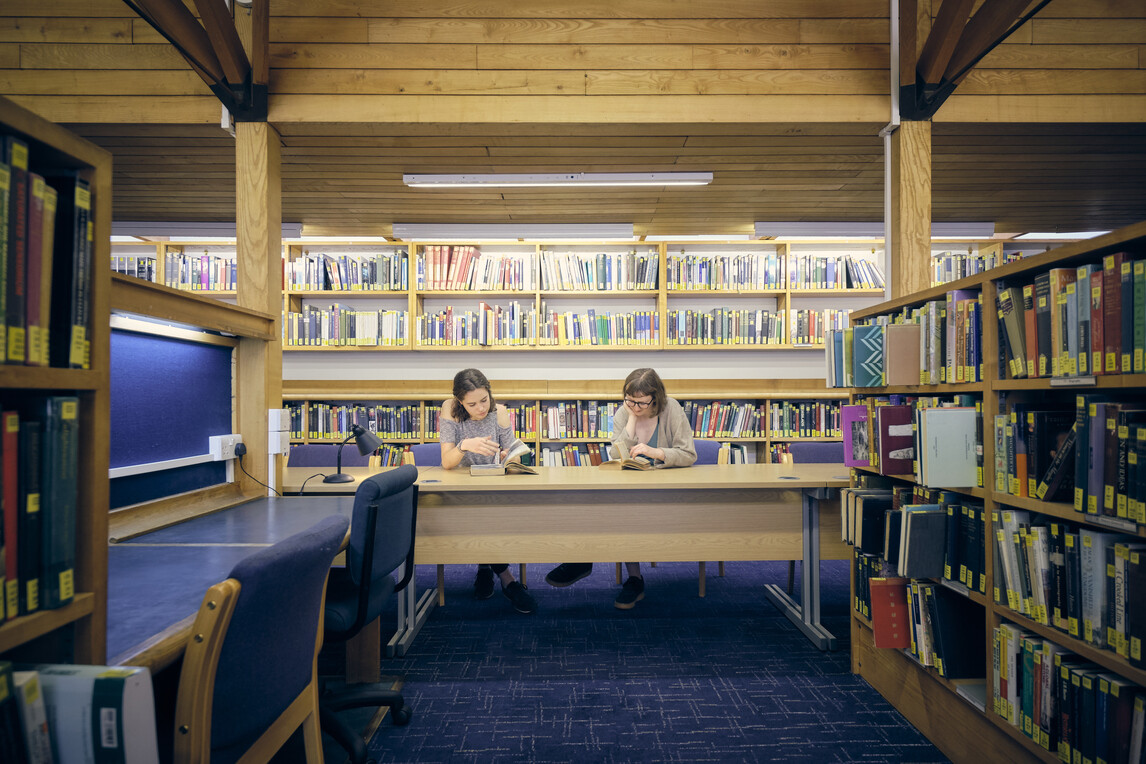 Two students reading at desk