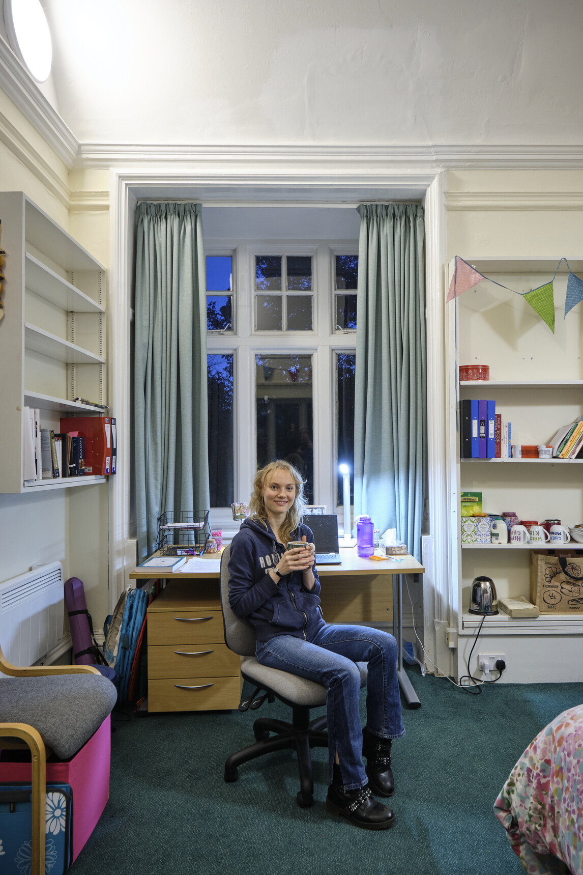 Student on swivel chair in front of desk