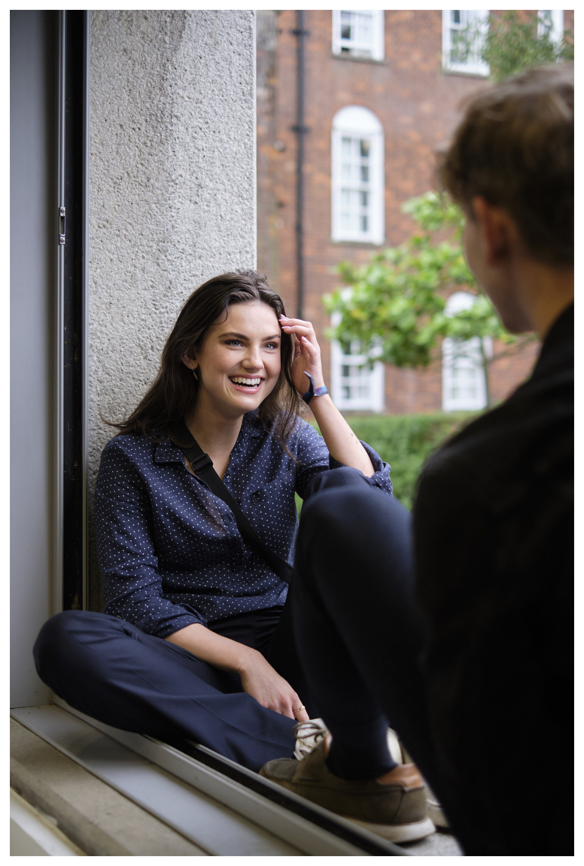 Students chatting at the common room window