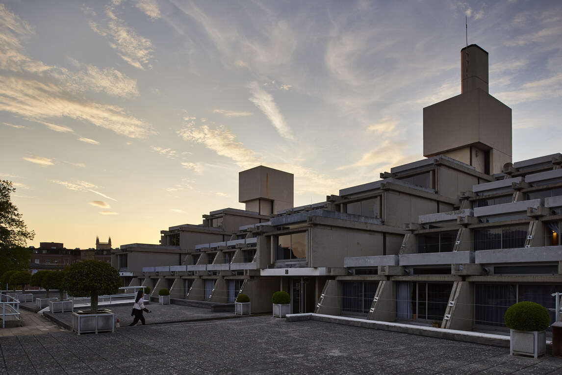 Upper level at sunset. Female student walking