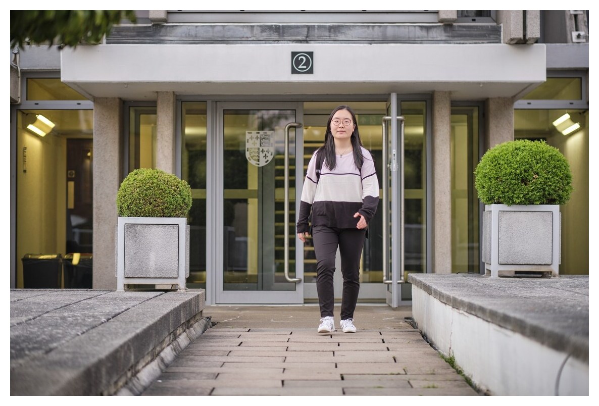Student walking out of New Court staircase 2