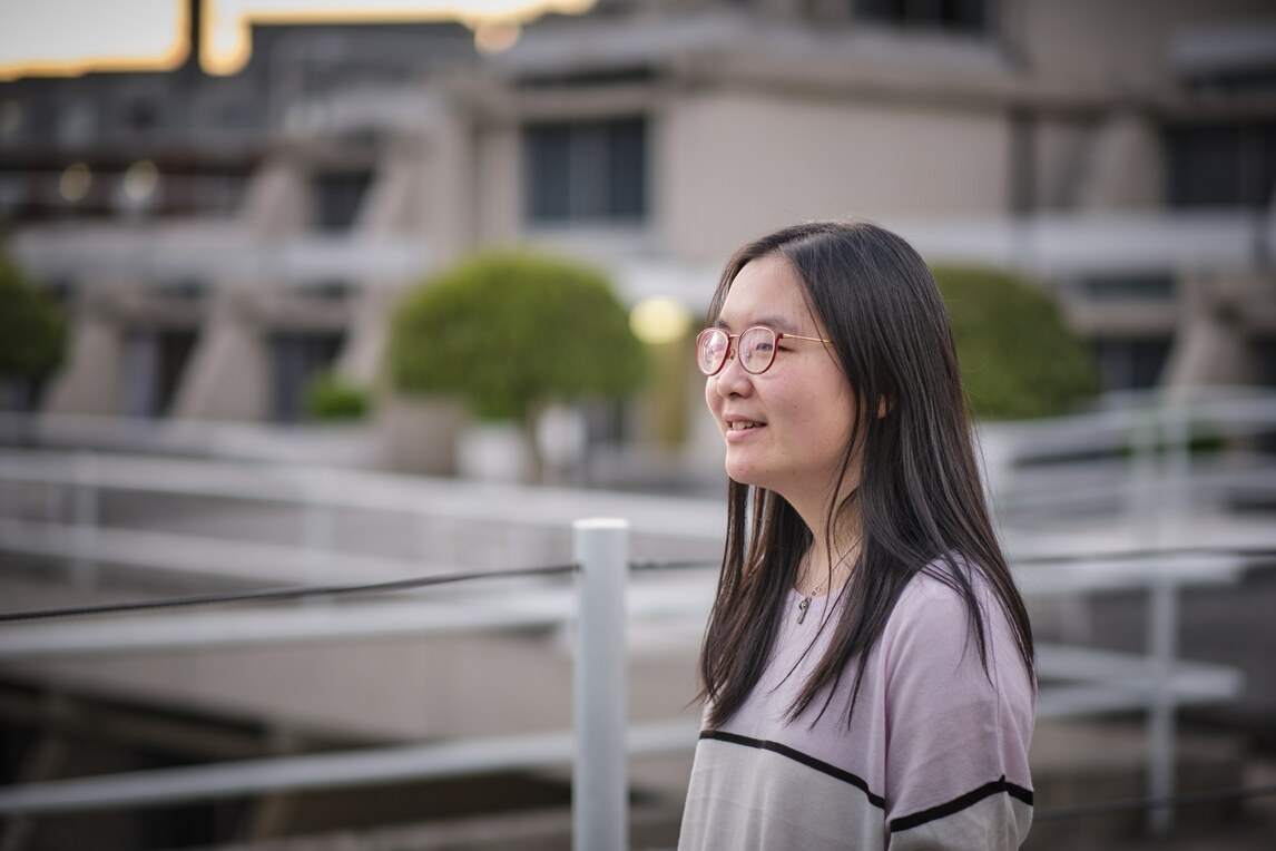 Student in front of blurred buildings