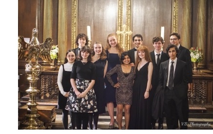 A group of students in formal dress in the chapel of Christ's College, Cambridge.