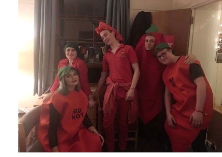 Five students, dressed as chilies, in a student room at Christ's College, Cambridge.