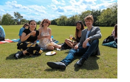 A group of students lounging on some grass