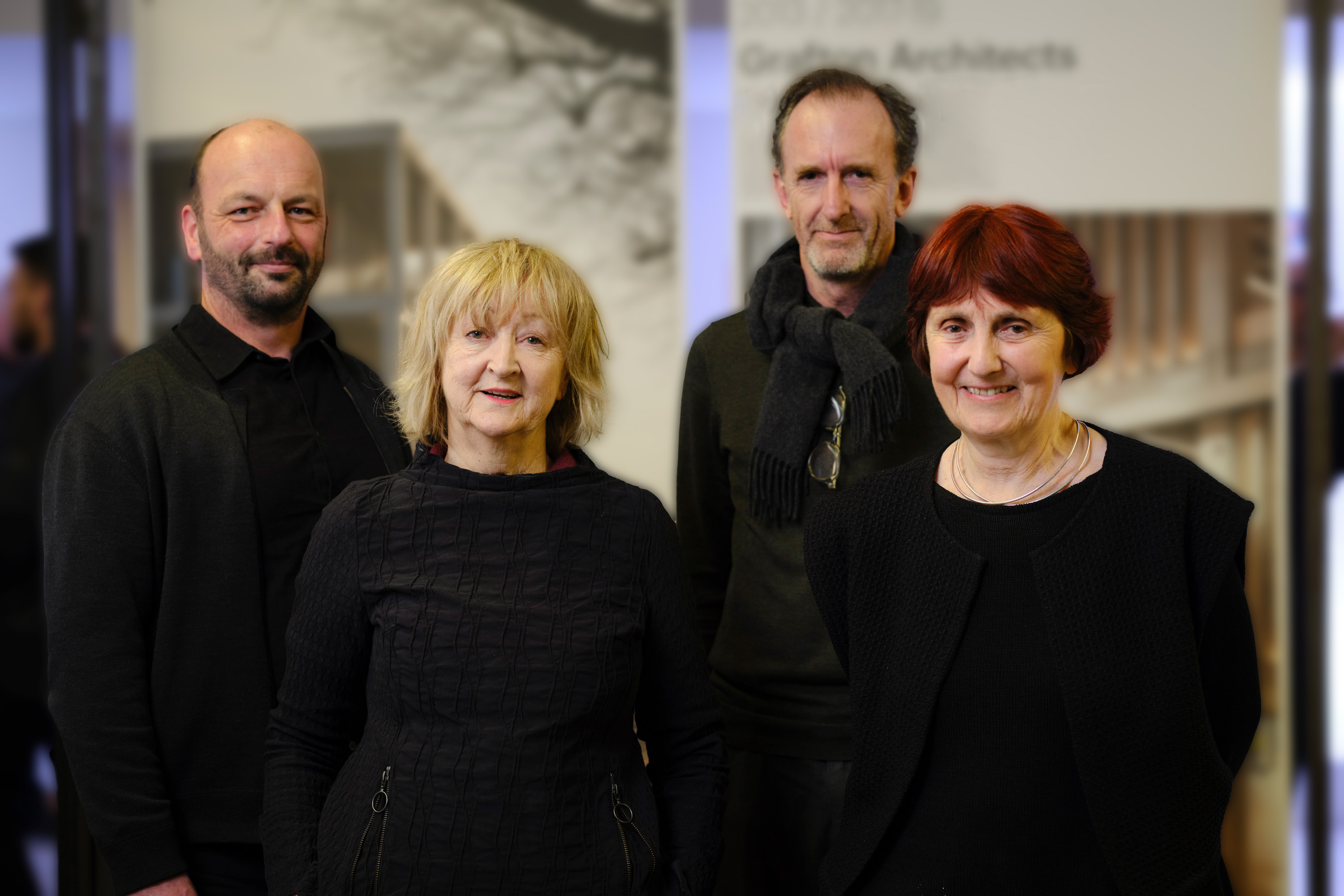 Four people dressed in black