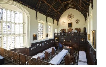 A view of the Hall at Christ's College, Cambridge, from the balcony. The Hall is set up for a formal dinner but empty.