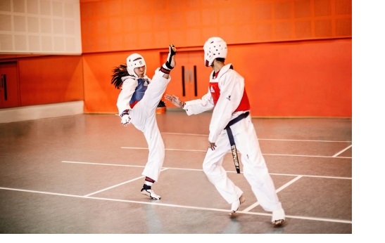 Two combatants in the middle of a taekwondo bout, with Cambridge University Taekwondo at the University Sports Centre in West Cambridge.
