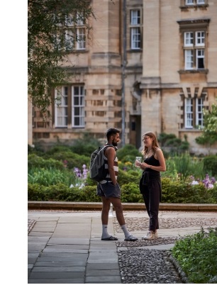Two students standing in the entrance to Third Court at Christ's College, Cambridge.
