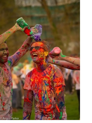 A man being covered in paint at the annual Holi celebration organised by the University of Cambridge Hindu Cultural Society