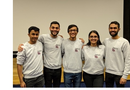 Five students in Cambridge University India Society sweatshirts posing for a photo.