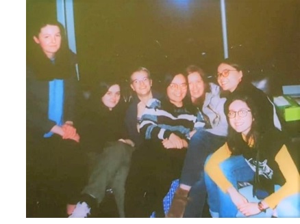 A Polaroid of a group of young women sat on a sofa
