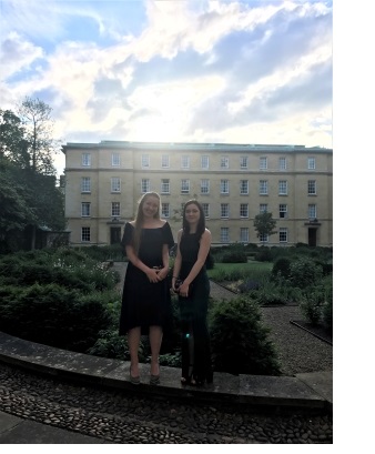 Two young women standing in Third Court at Christ's College, Cambridge.