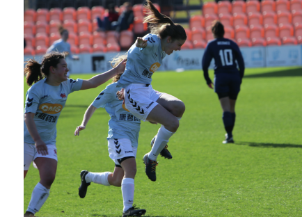 Members of Christ's Ladies' Football team celebrating a goal in a Cuppers match.