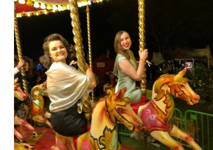 Ruby and a friend riding a carousel at a May Ball