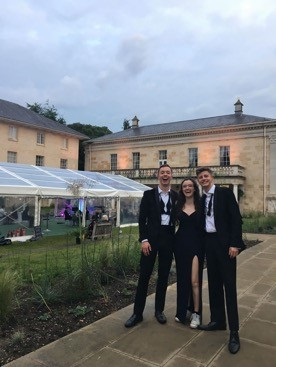 Two male students, in black tie, posing in Third Court at Christ's College, Cambridge.