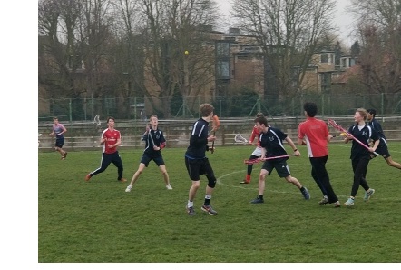 Players in the middle of a mixed lacrosse match.