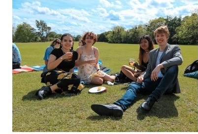 Olivia and friends lounging around on some grass