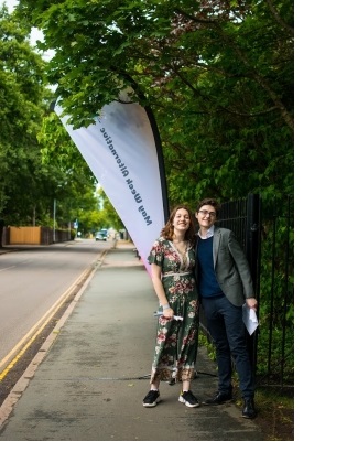 Two students at the gates of the 2019 May Week Alternative party in Cambridge.