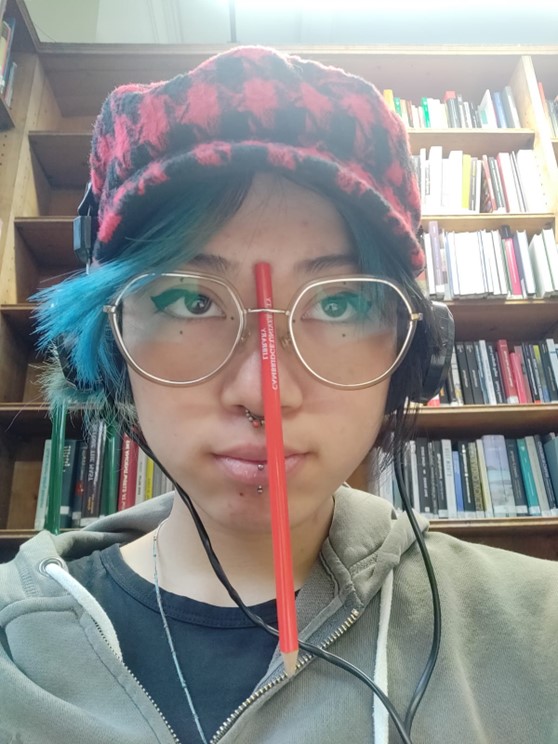 Ari with a pencil hanging from her glasses