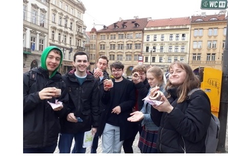 A group of young men and women with chimney cake in Prague