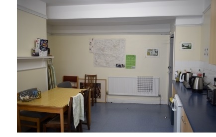 A student kitchen in Q staircase at Christ's College, Cambridge. The kitchen contains a large table, two fridges, two kettles, two hobs, a toaster and other facilities.