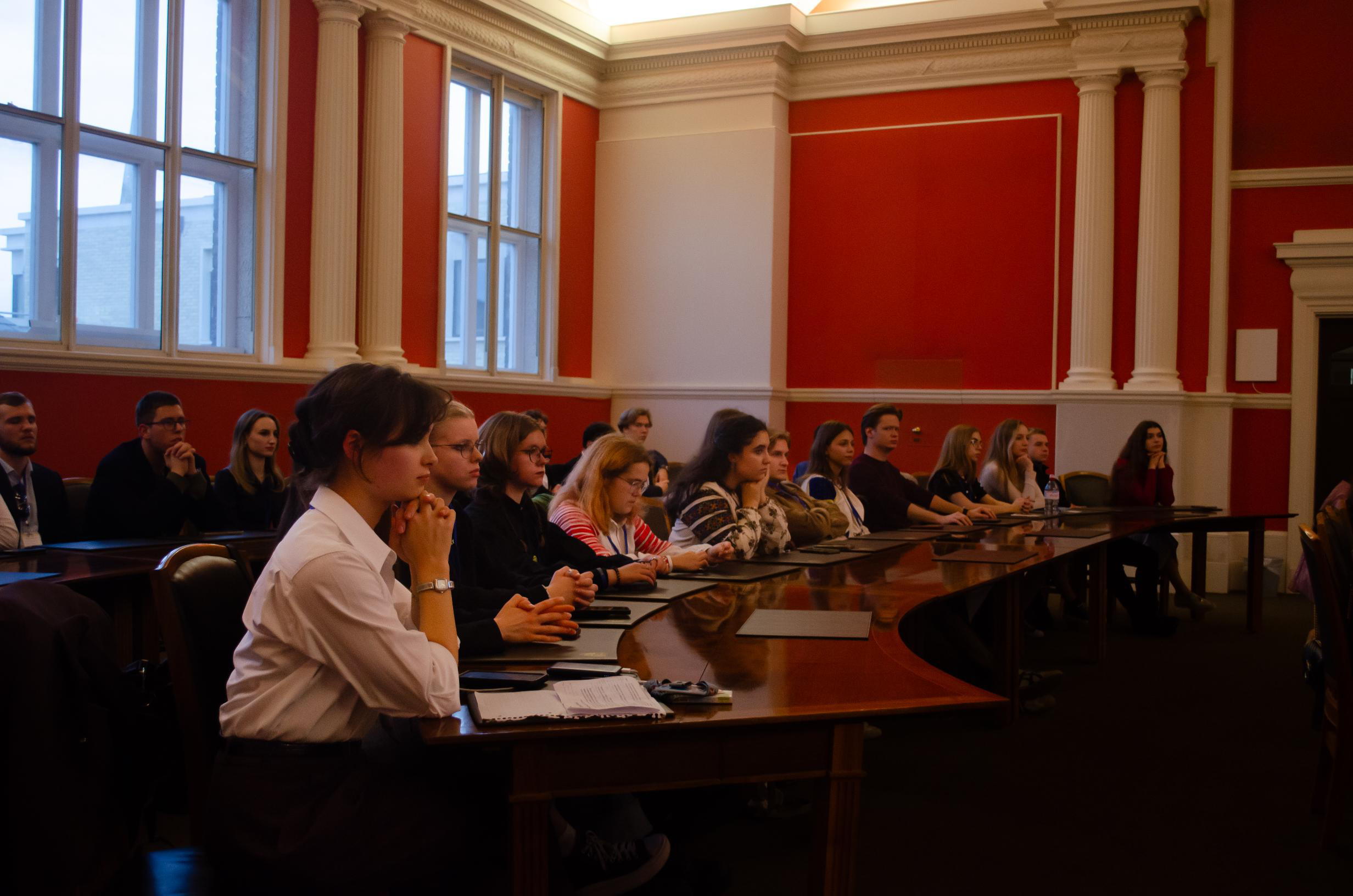 People seated at tables viewed from the side