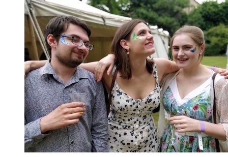A man (left) and two women (centre and right) at the Cambridge Union Garden Party at Sidney Sussex College, Cambridge.