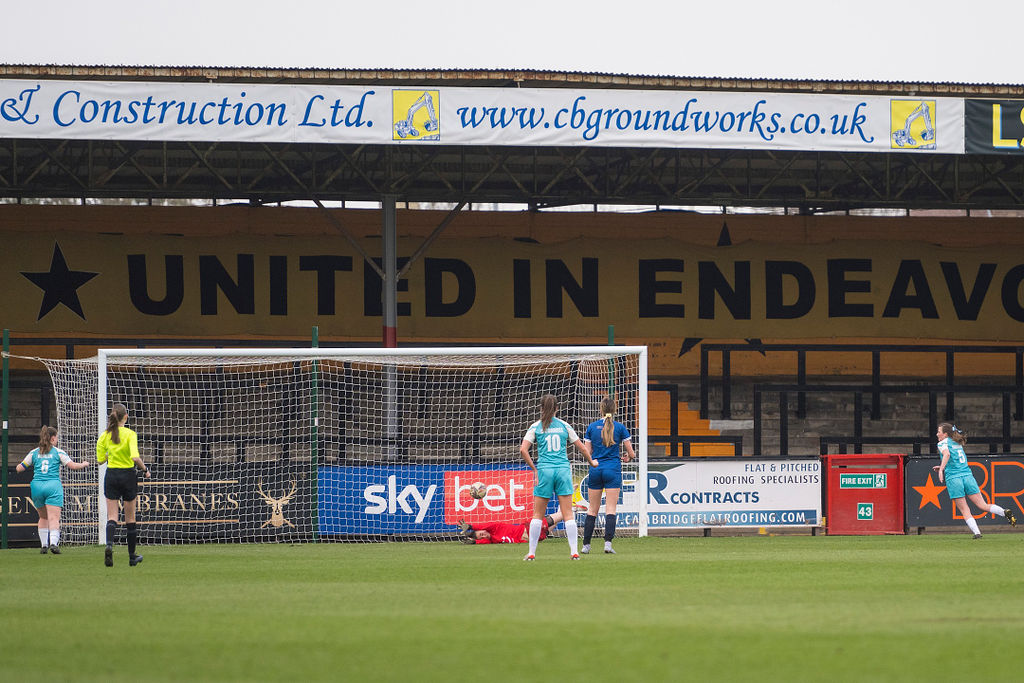 A football match with goalkeeper arms stretched