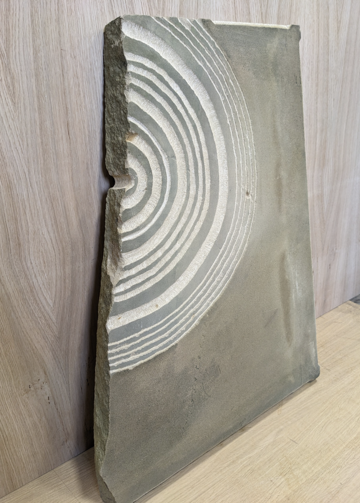 Sculpture with radiating circles chiselled on stone