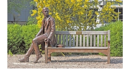 A statue of a young Charles Darwin on a bench in New Court at Christ's College, Cambridge.