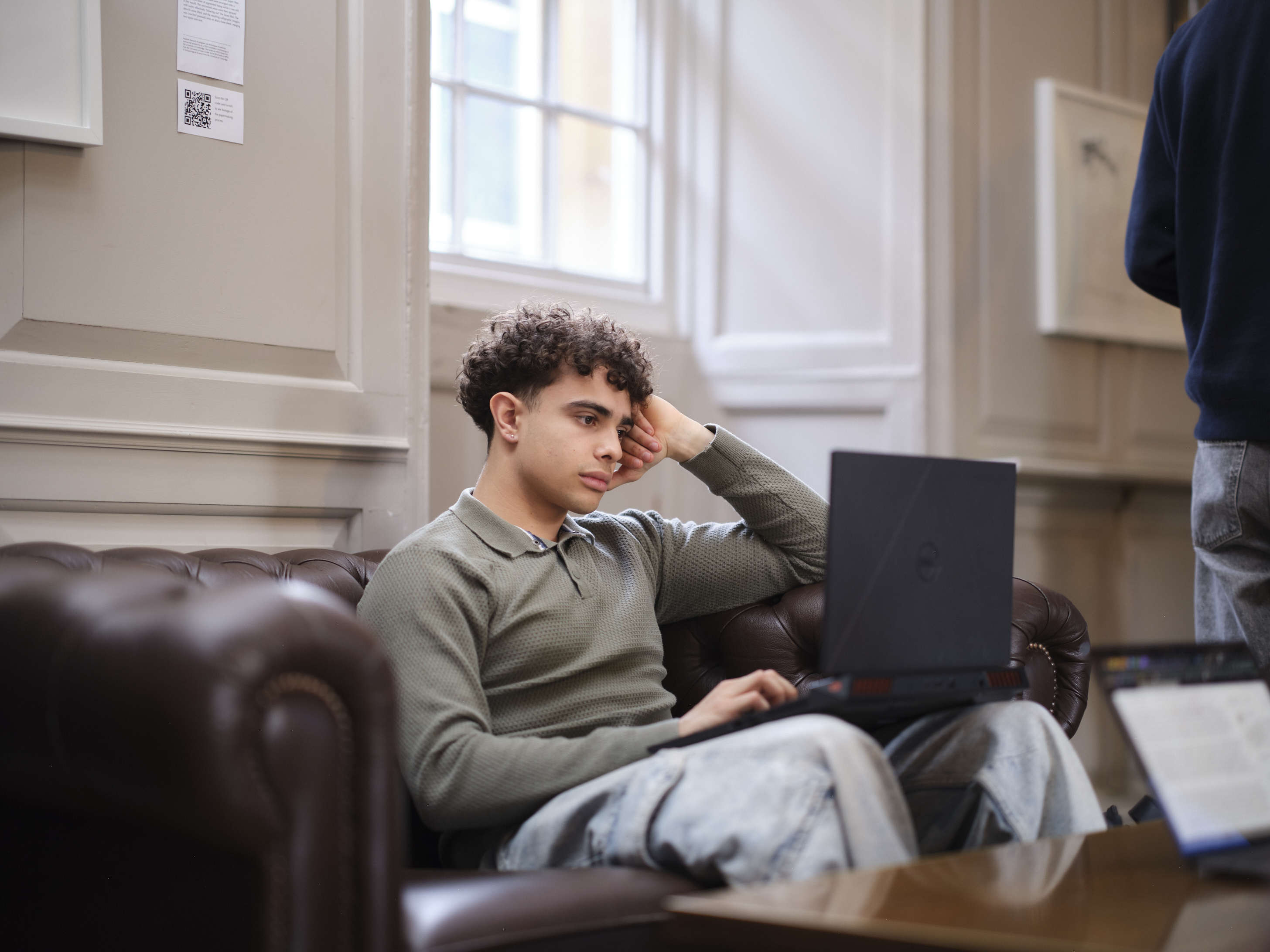 Student reading material on a laptop