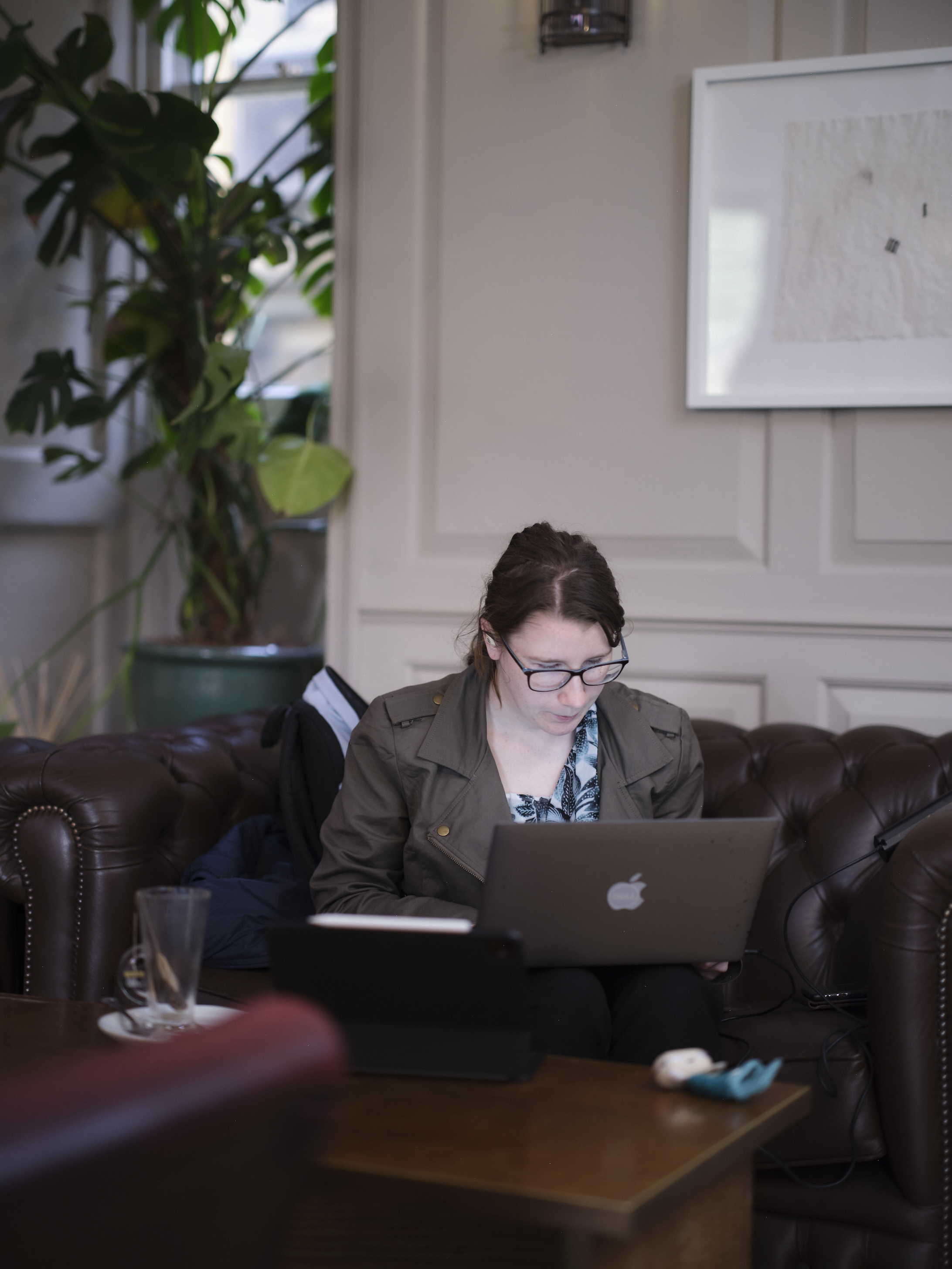 Student on sofa, working on laptop