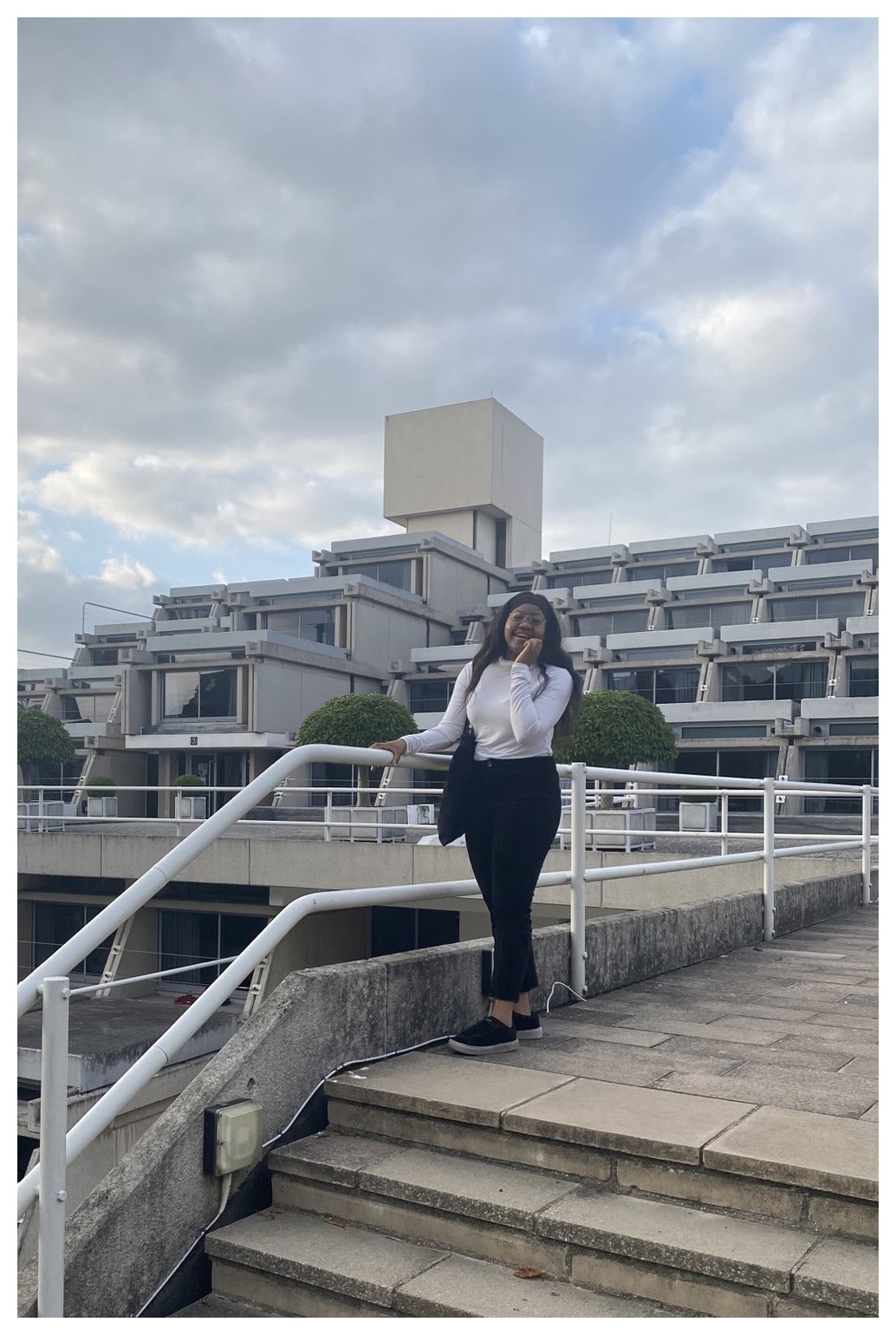 Eri stands on the steps of the Typewriter building