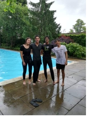 Hannah and three friends posing after having jumped fully-clothed into the Christ's College pool following their end-of-year exams.