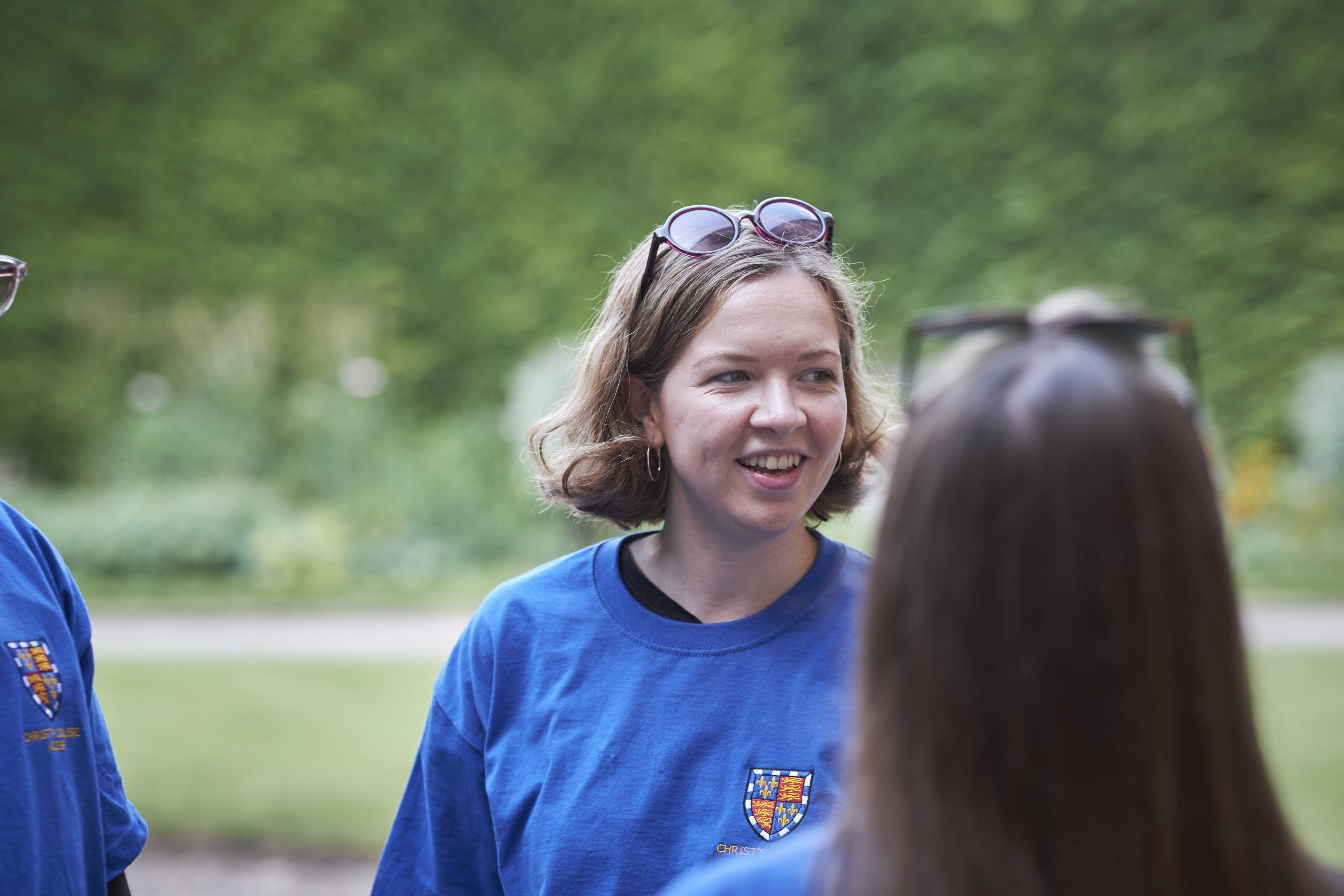 Student talking in blue T shirt