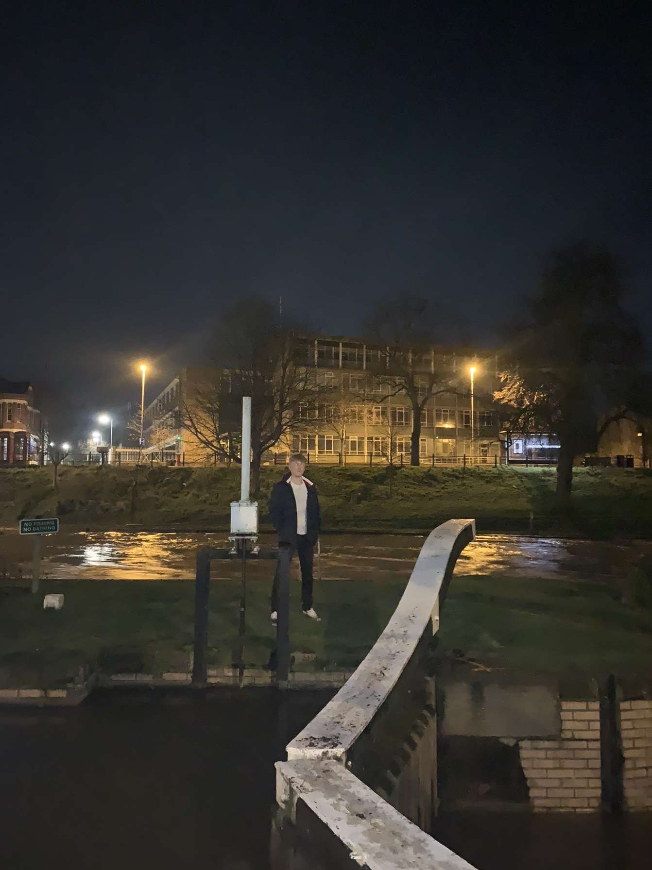 James in front of the river Cam at night