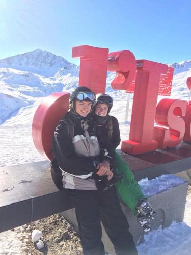 Two students standing on the slopes