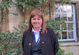 Headshot of Lisa outside the Porters' Lodge