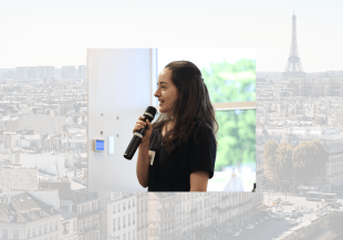 Headshot of Lea against a Paris rooftops background