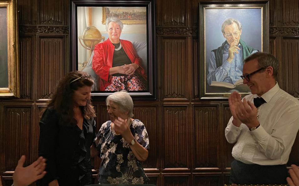 Three people in front the a portrait