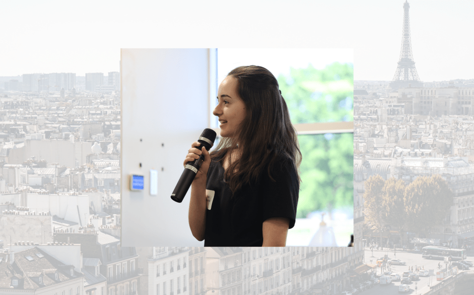Headshot of Lea against a Paris rooftops background